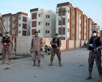 SUKKUR, March 17, 2020 (Xinhua) -- Pakistani security officials stand outside a quarantine facility for people returning from Iran in southern Pakistan